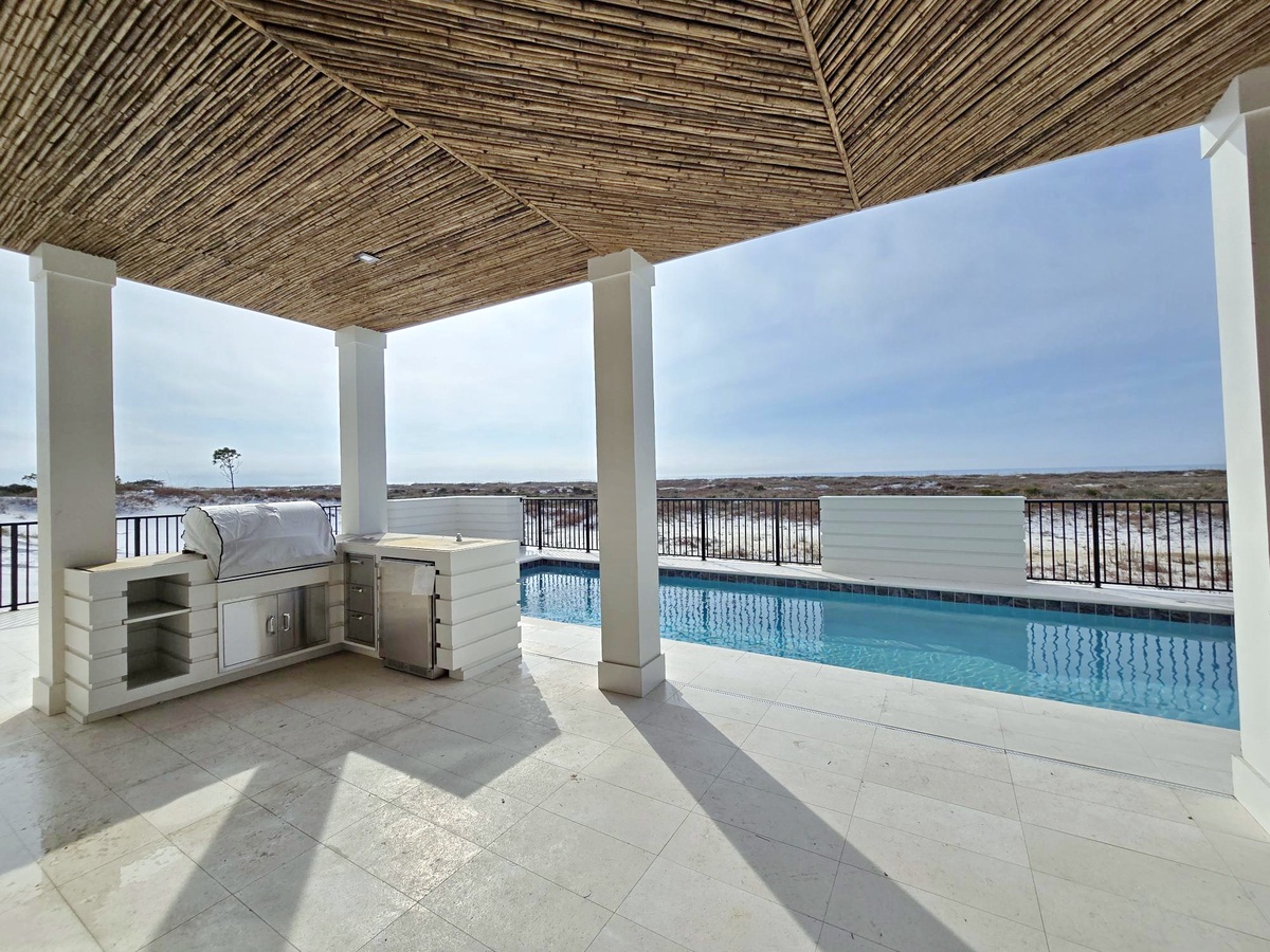 Your private poolside paradise awaits with an outdoor kitchen for lakefront dining bliss.