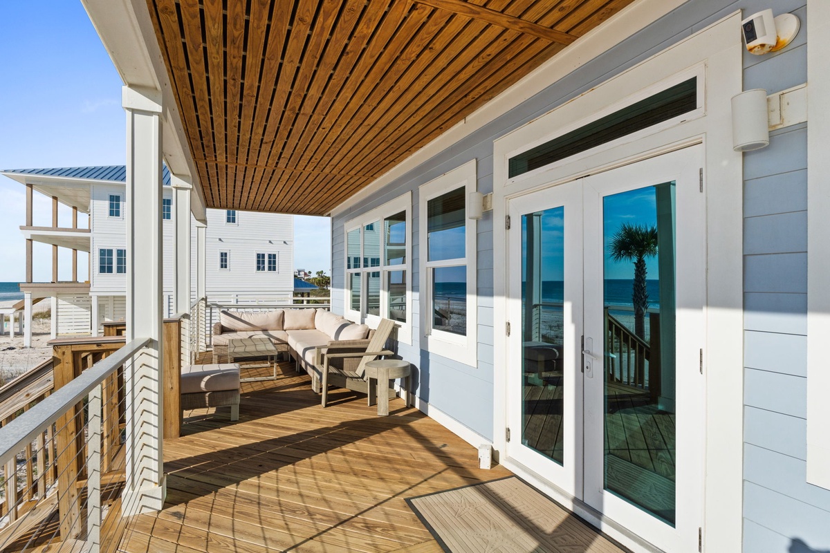 Unwind on your private covered balcony with plush seating overlooking the stunning coastal scenery and pristine beach views.