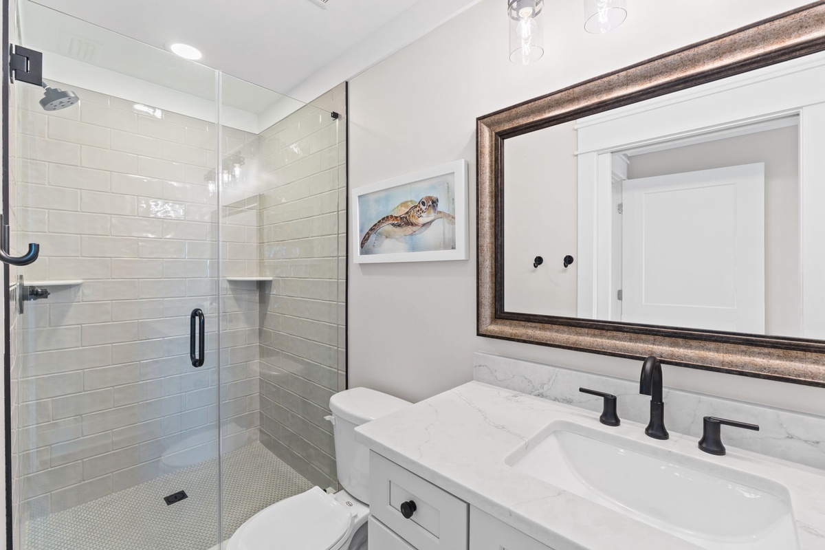 Refresh in your bright, modern bathroom with a spacious walk-in shower and coastal-inspired décor.