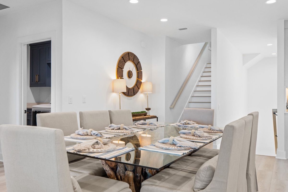 Gather around your elegant glass dining table for memorable meals in this sophisticated open-plan space.