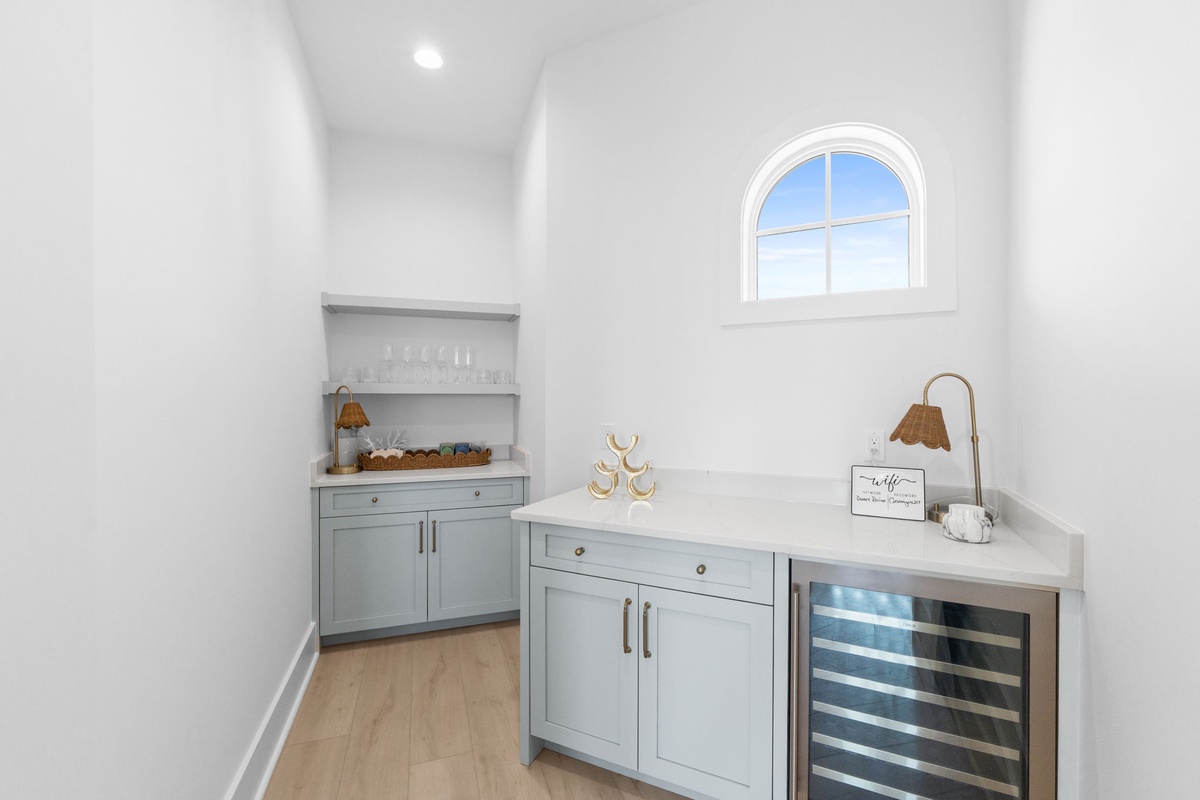 Your private butler's pantry features elegant sage cabinetry, marble counters, and wine storage for effortless entertaining.