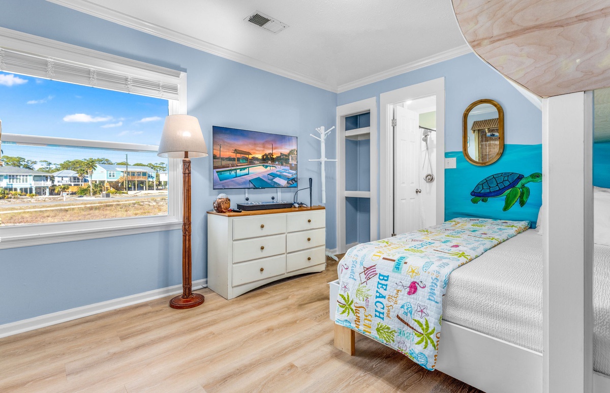 Your kids will love this ocean-themed bunk room with its vibrant turtle mural and beach-themed bedding, creating magical bedtime adventures.