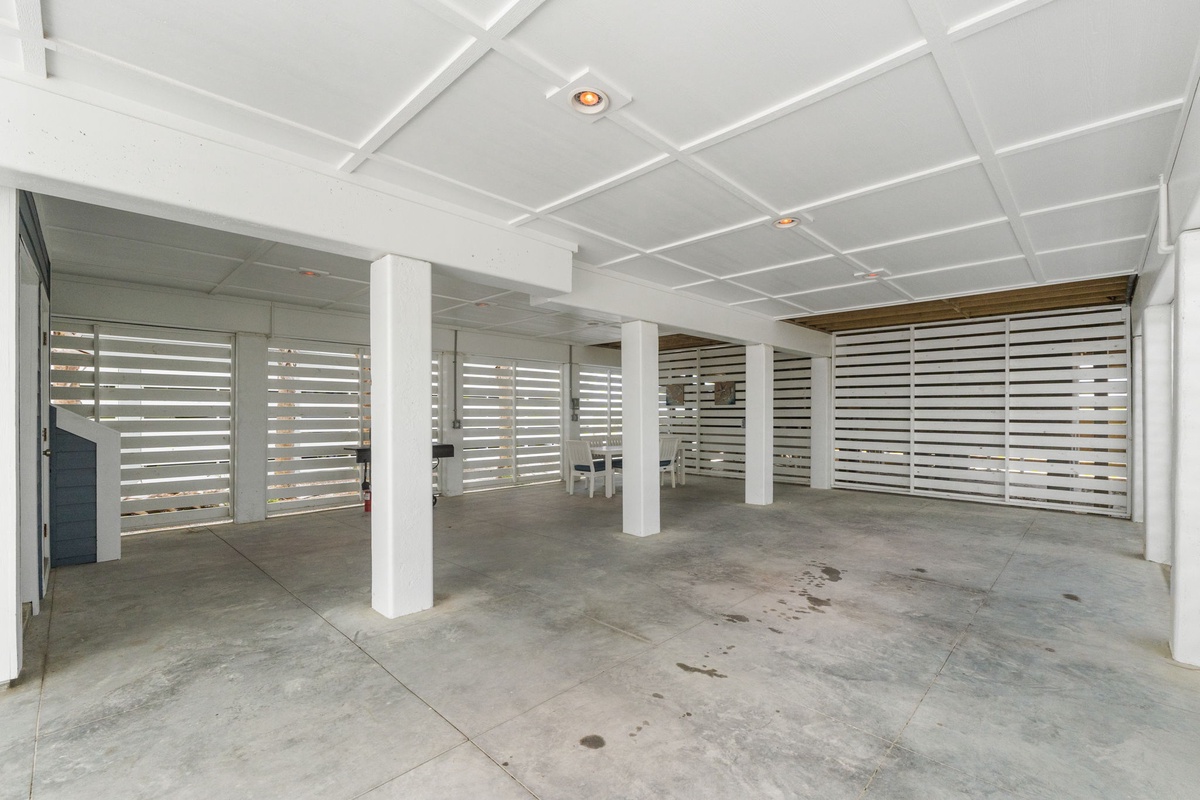 Spacious covered parking area with modern architectural details and secure access, conveniently located beneath the property.