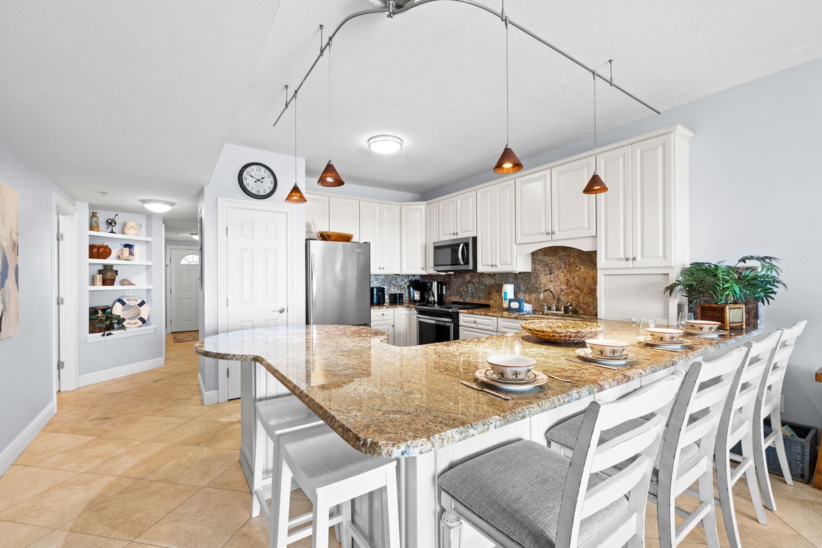 Your spacious kitchen invites culinary adventures with granite countertops, modern appliances, and a large island perfect for group meals and conversation.