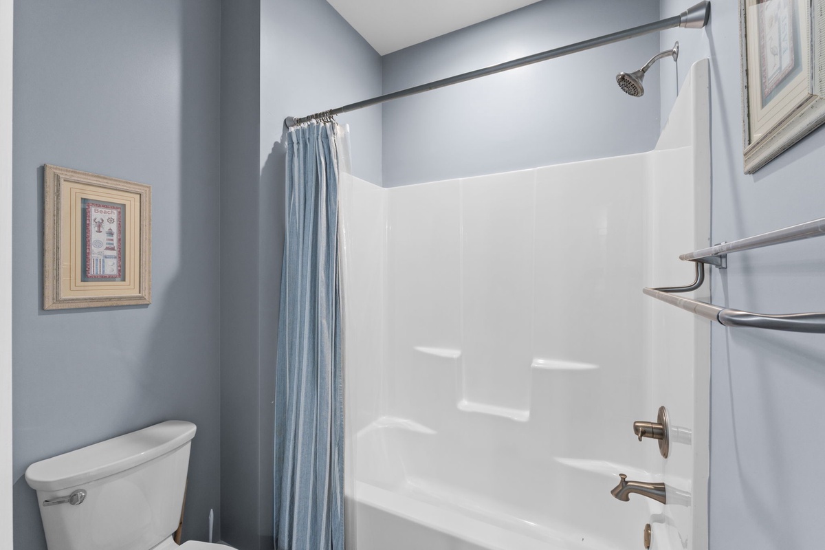 Refresh in your private bathroom with a clean tub-shower combo and soothing blue walls that create a spa-like retreat.