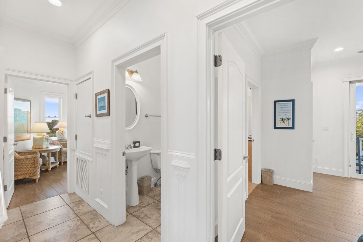 A bright, welcoming hallway connects your living spaces with coastal-inspired touches and charming details throughout. Natural light fills the area, inviting you to explore your home away from home.