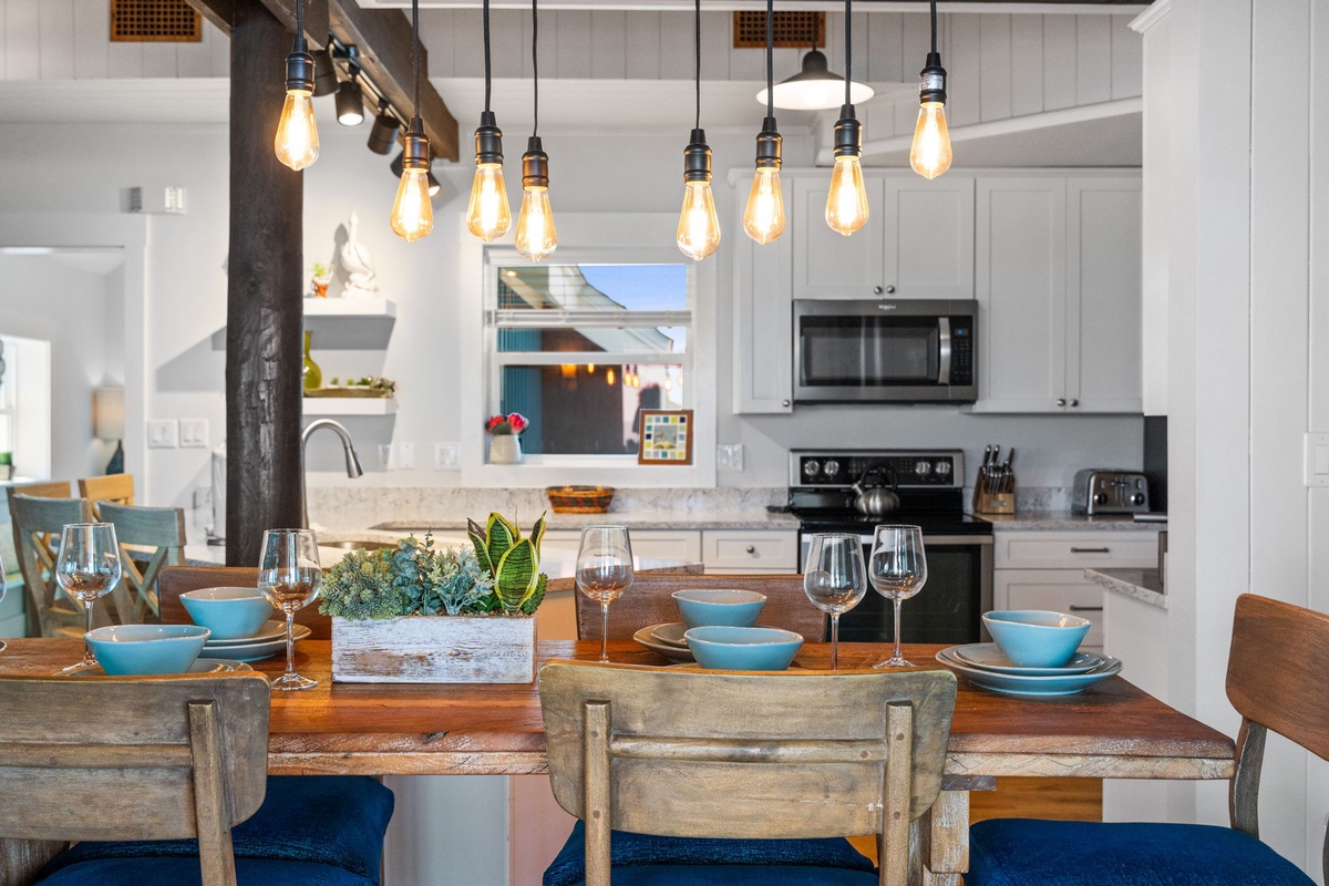 Gather around this welcoming dining table where warm Edison bulbs glow overhead and you'll find everything you need to cook and share memorable meals together.