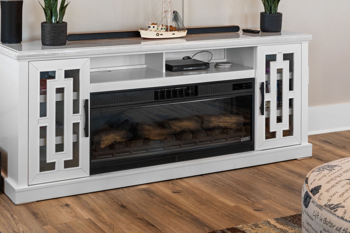 Coastal charm meets modern comfort in this elegant media console with built-in fireplace, ready to anchor your relaxing evenings.