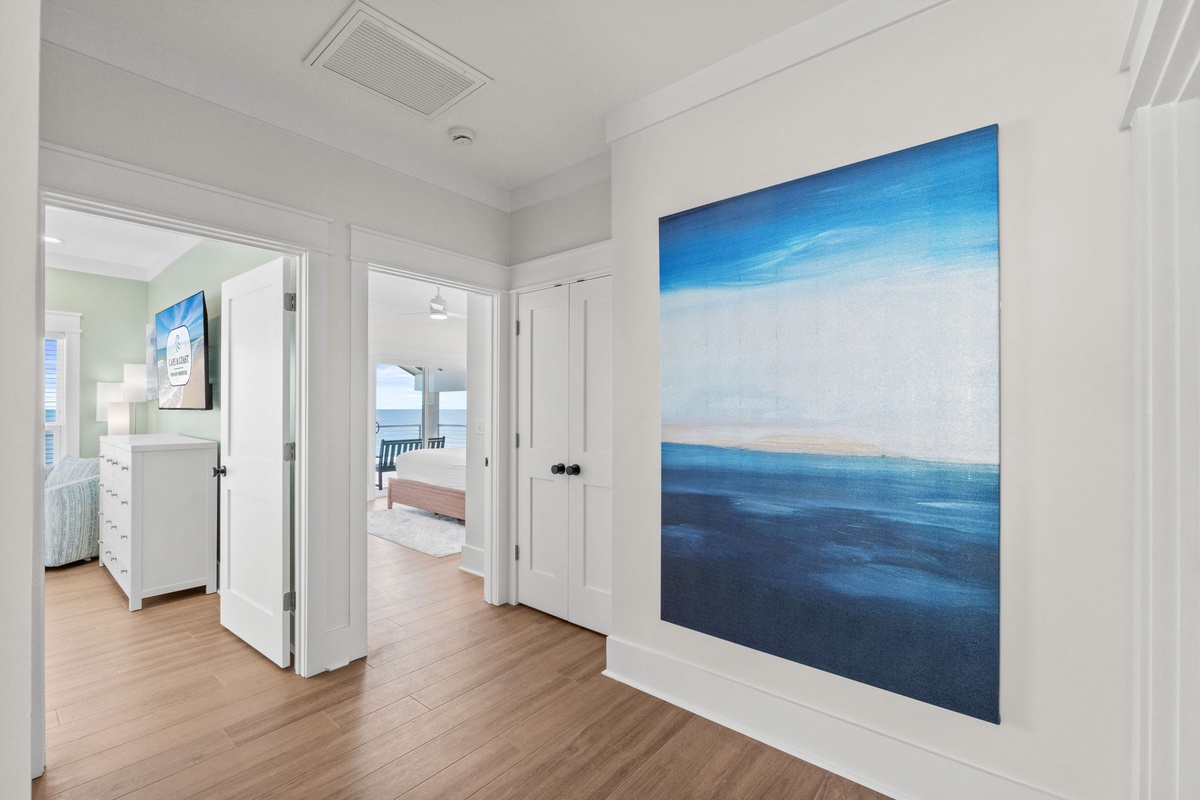 Step into your coastal retreat where a stunning ocean-inspired painting sets the tone for your stay. Beyond these doors, your private oceanfront balcony awaits.