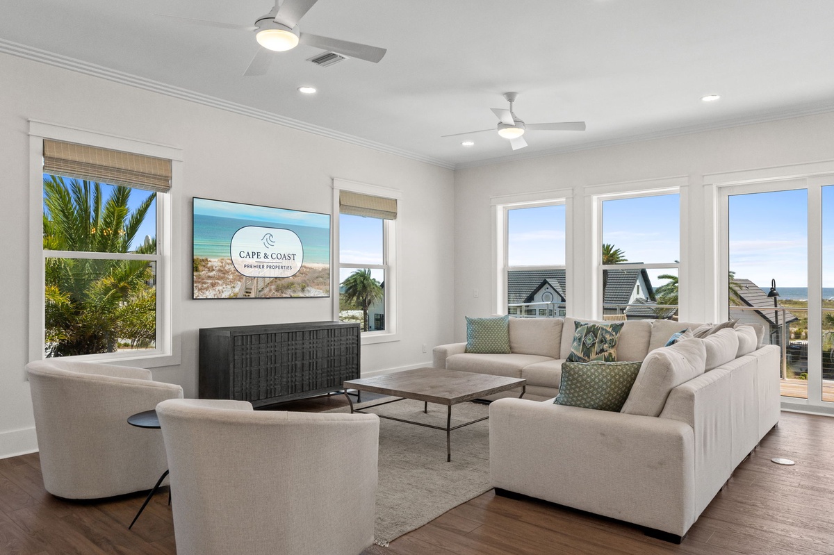 Settle into your bright and airy living space where ocean breezes meet coastal calm. The open layout invites you to unwind with plush seating and glimpses of the sea beyond.
