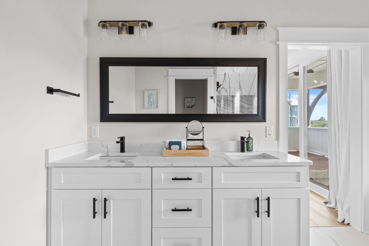 Freshen up in this beautiful dual-sink bathroom with elegant marble countertops, sleek fixtures, and a spacious vanity for all your essentials.