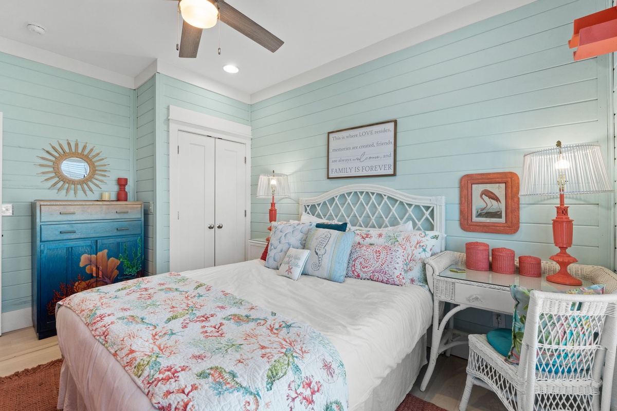 Drift off in this coastal-themed bedroom where soft aqua walls and coral accents create your perfect seaside retreat.