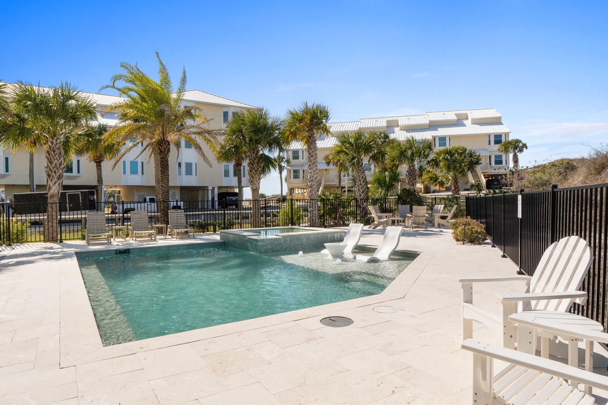 Relax by your sparkling pool surrounded by swaying palms and comfortable lounge chairs in this tropical paradise setting.