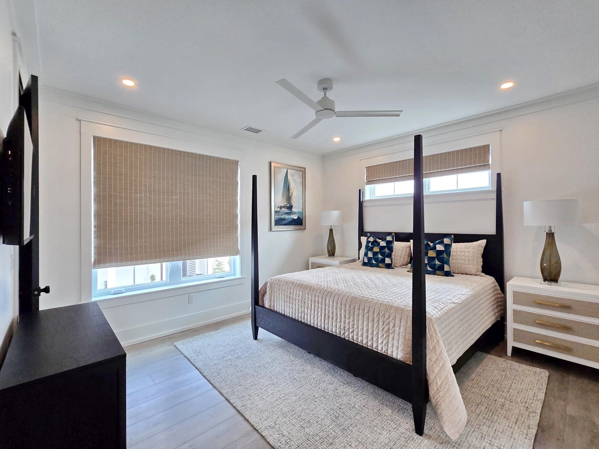 Drift off in your elegant four-poster bed with crisp linens, natural light streaming through bamboo blinds, and gentle ceiling fan breezes.