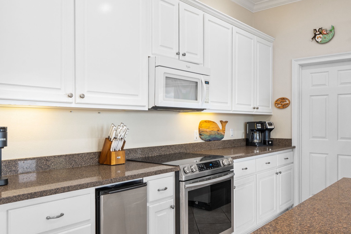 Prepare delicious meals in your spacious kitchen featuring granite counters, stainless appliances, and bright white cabinetry.
