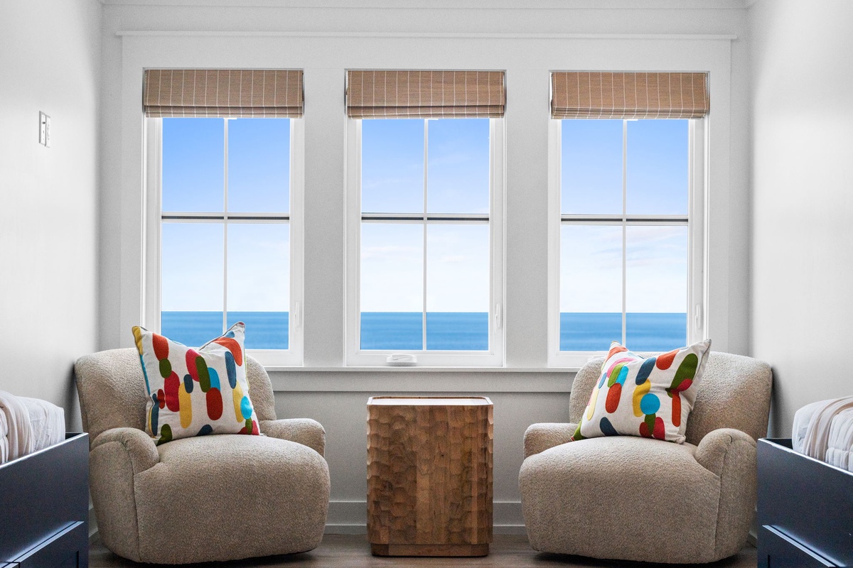 Wake up to unobstructed ocean views through three bright windows. Sink into plush armchairs with cheerful pillows as you sip your morning coffee and listen to the waves.