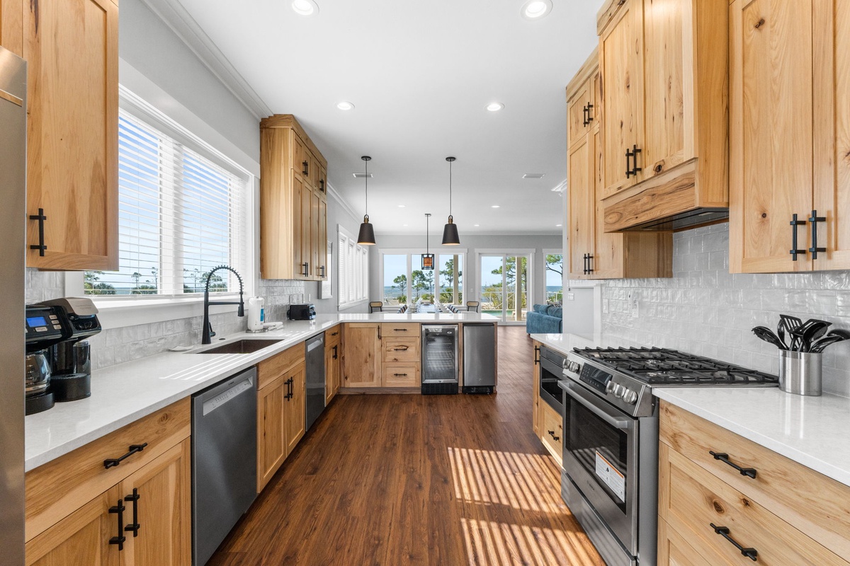 Your chef-worthy kitchen awaits with premium appliances, warm wood cabinetry, and marble counters perfect for preparing memorable meals.