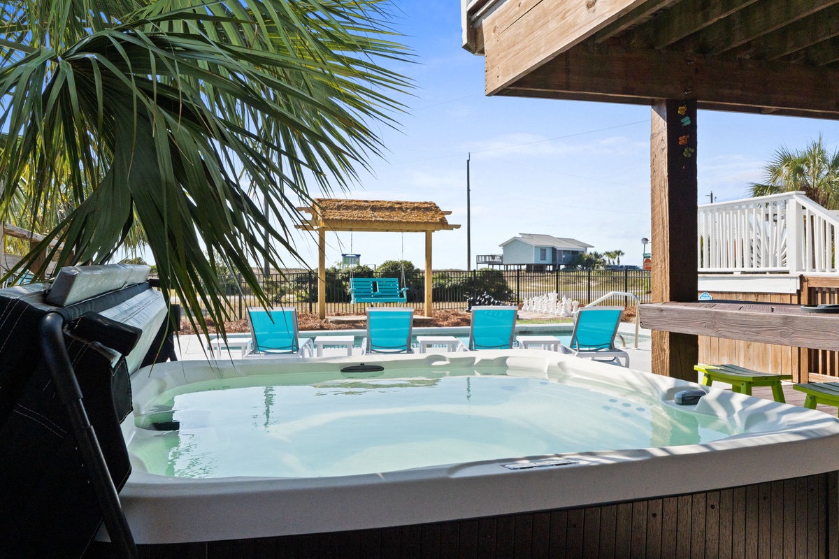 Soak and unwind in the hot tub with views of the pool and surrounding outdoor amenities