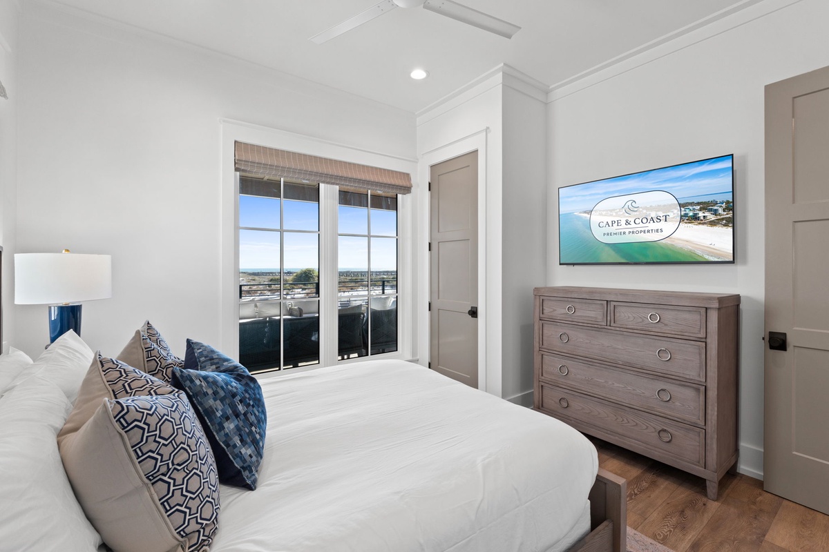 Unwind in your serene bedroom featuring crisp linens, elegant furnishings, and stunning coastal views from your private balcony.