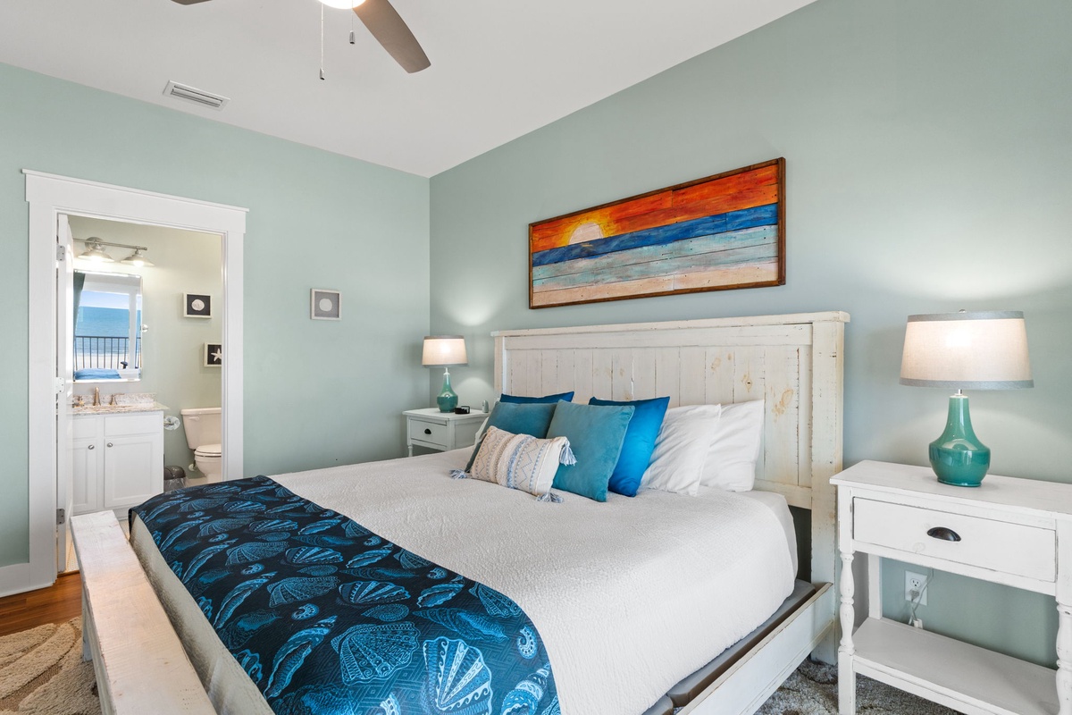 Drift off in this breezy coastal bedroom where calming sea-glass walls and crisp white linens create your perfect sanctuary. Let the ceiling fan lull you to sleep each night.