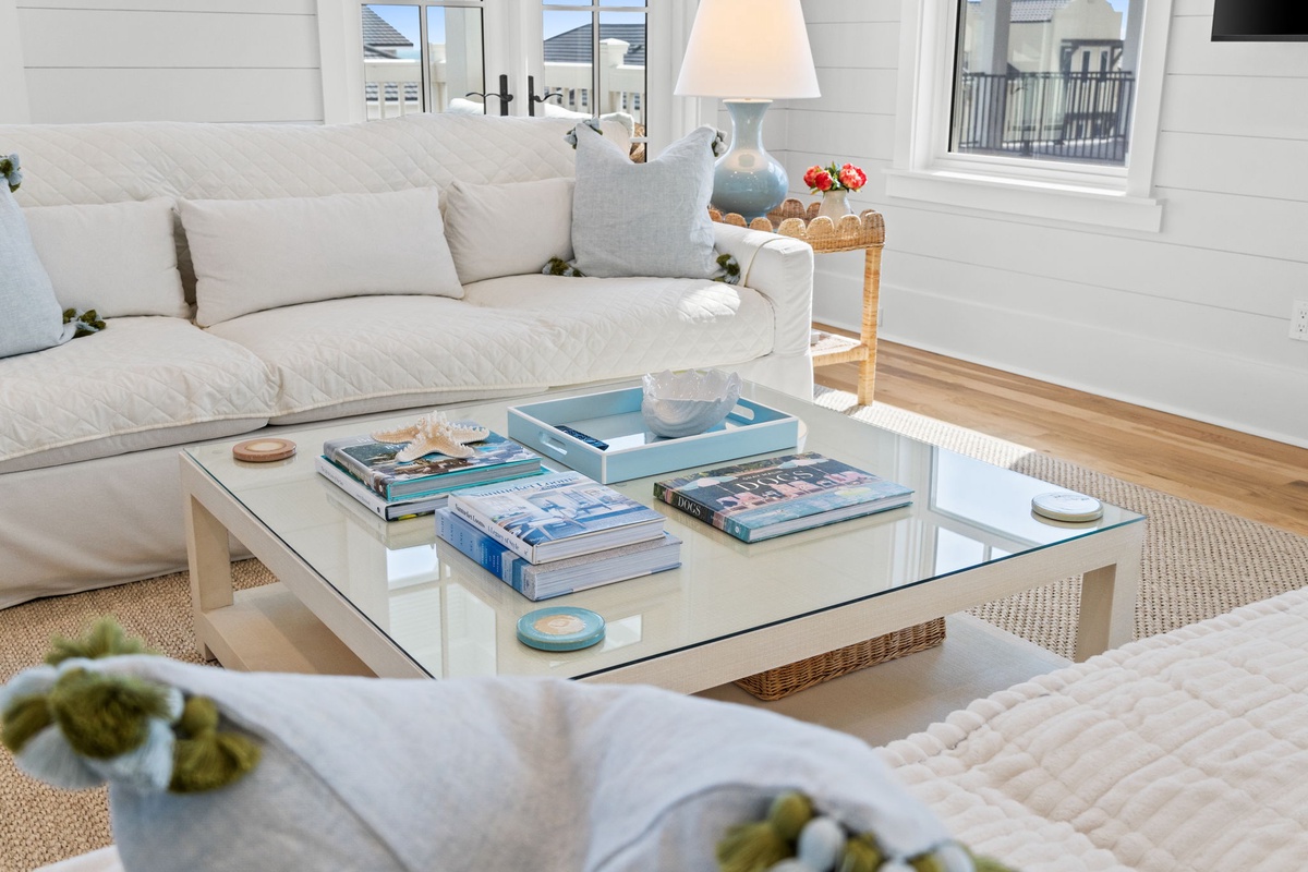 Sink into plush cushions and unwind in your serene coastal living room, where soft textures and calming blues create the perfect retreat after a day exploring.