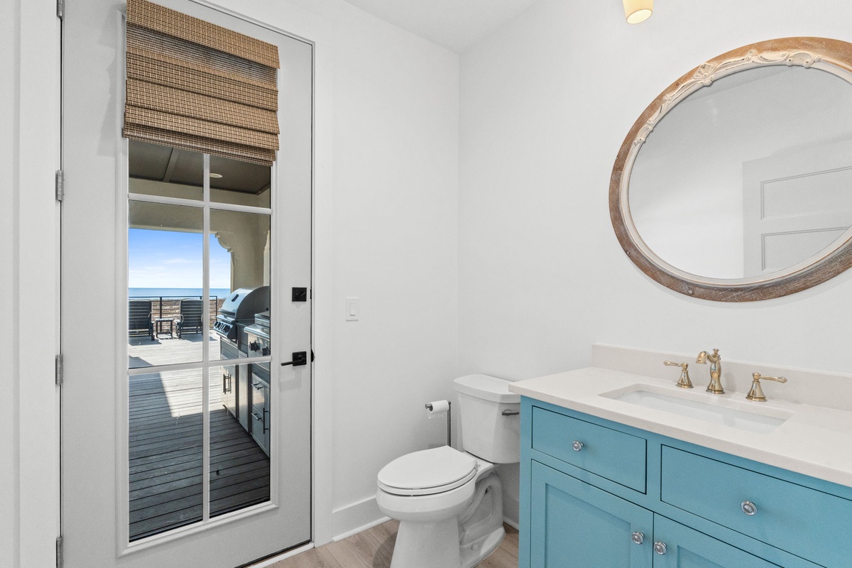 Refresh in your bright coastal bathroom with turquoise vanity and natural textures, then step onto your private deck.