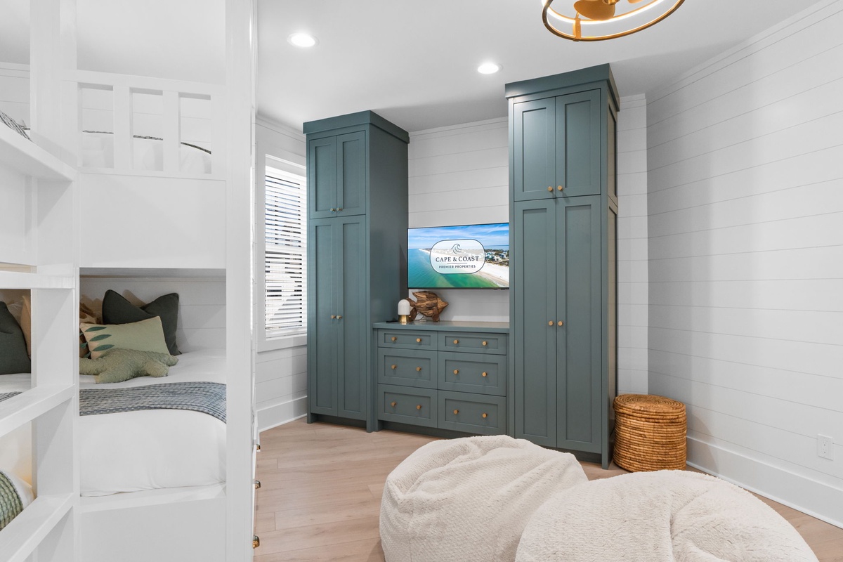 Your kids will love the custom bunk beds and ample storage in this thoughtfully designed bedroom with coastal charm.