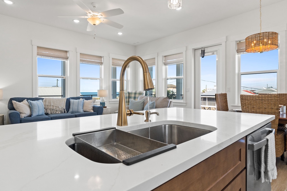 Your kitchen island overlooks stunning ocean views, making meal prep a joy with panoramic windows and coastal charm.