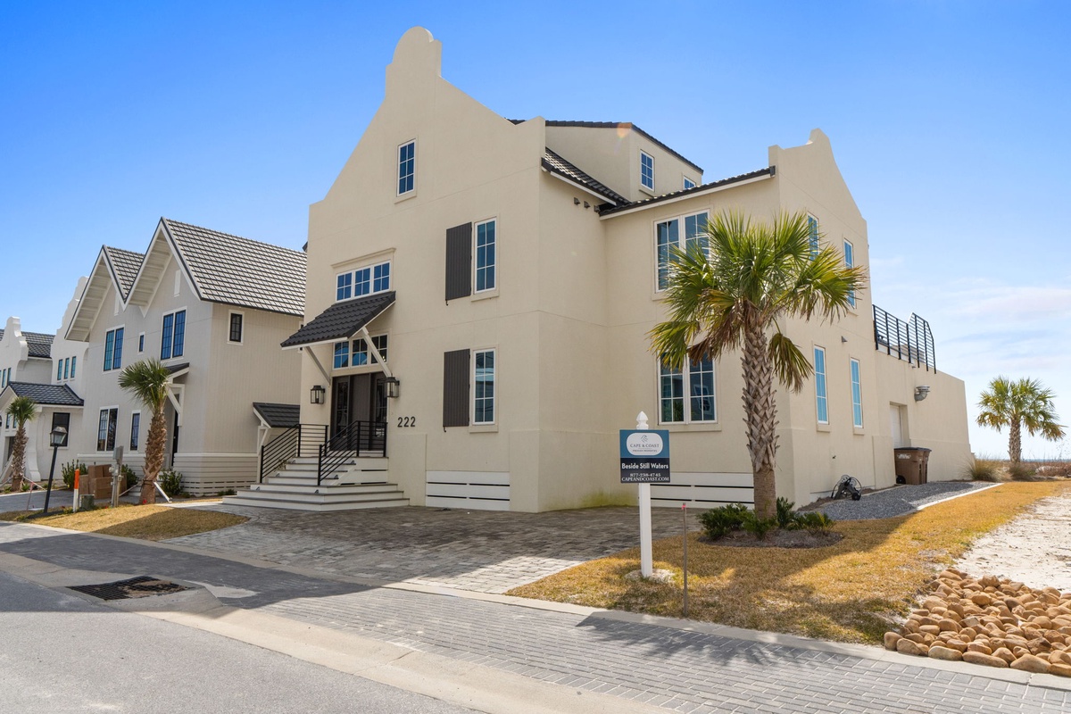 Contemporary beachside property featuring modern architecture and tropical palm trees in a pristine coastal neighborhood setting.
