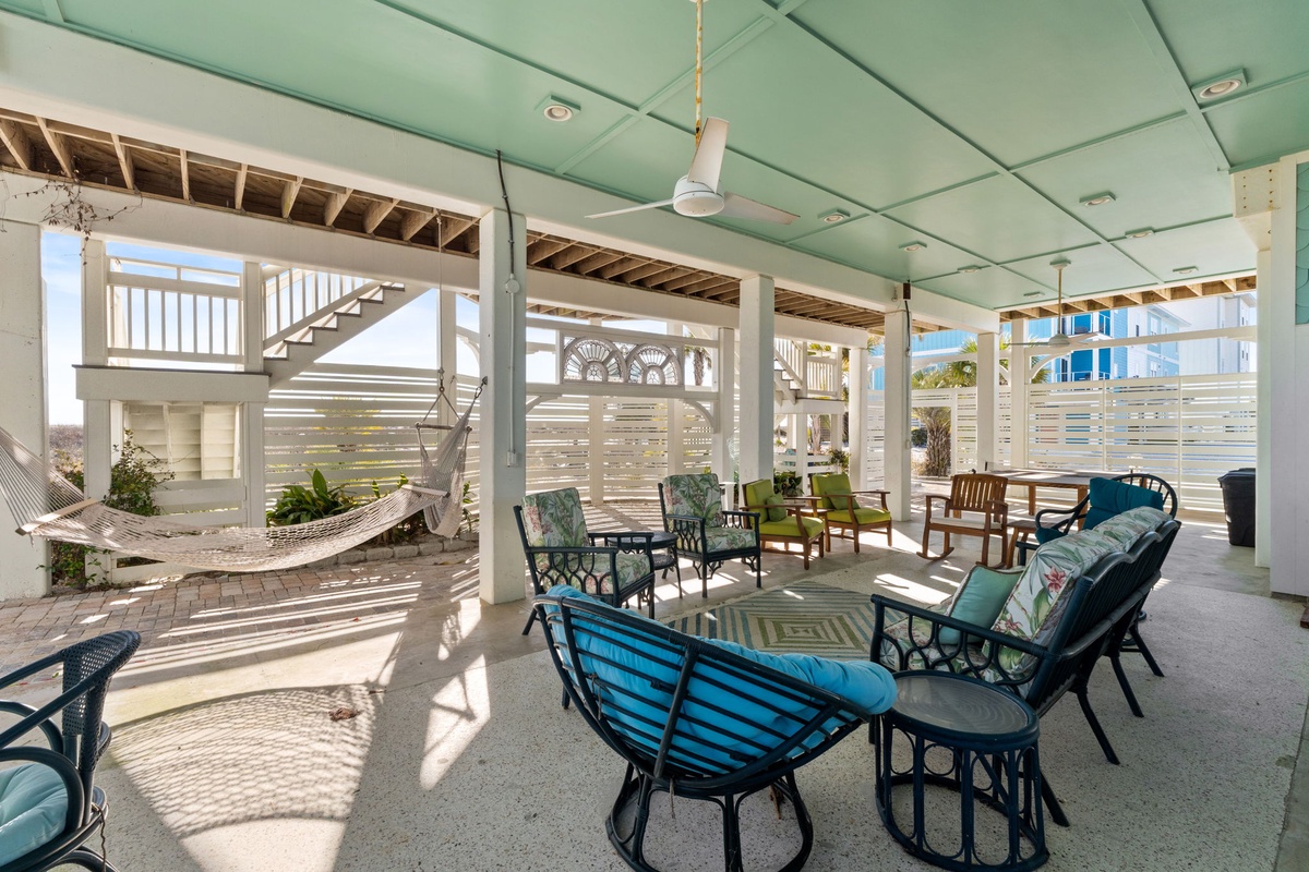 Unwind in your covered outdoor lounge with comfortable seating and gentle ocean breezes flowing through this peaceful retreat.
