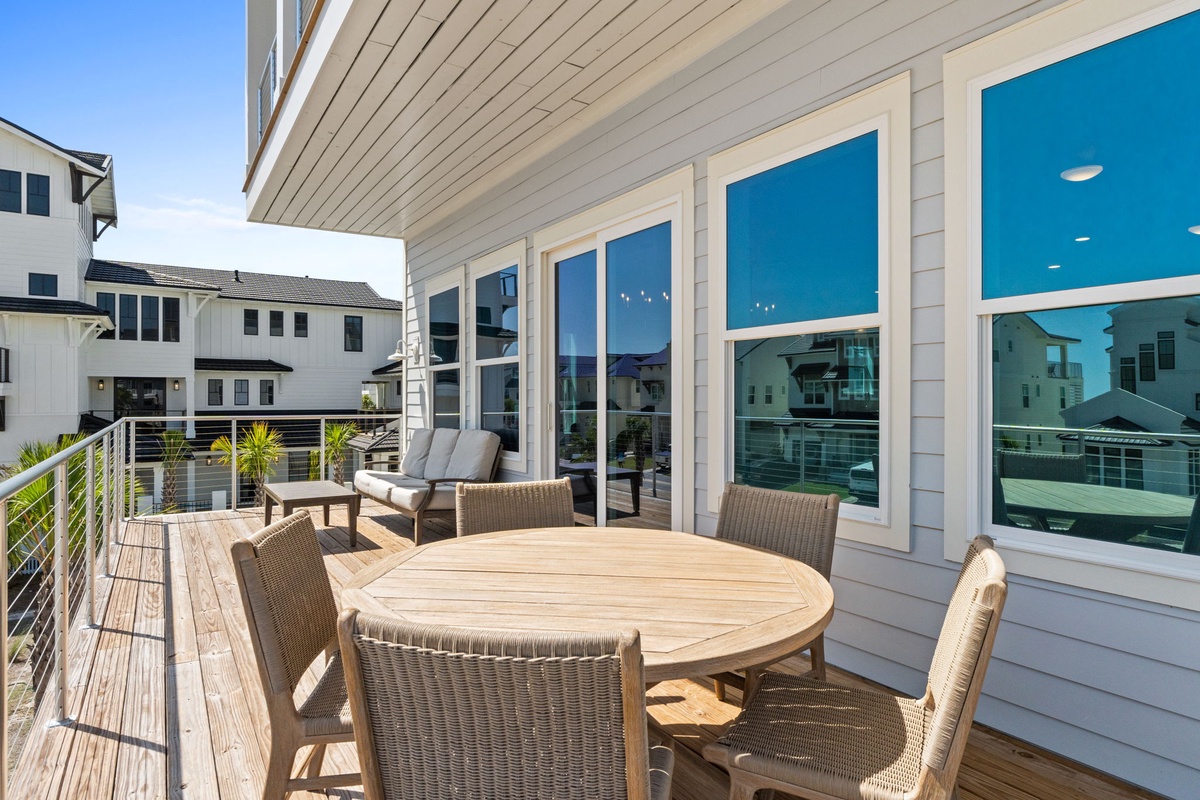 Step out onto your private deck where waterfront dining and relaxation await. This sun-drenched outdoor space offers comfortable seating and peaceful canal views—perfect for morning coffee or evening meals with family.
