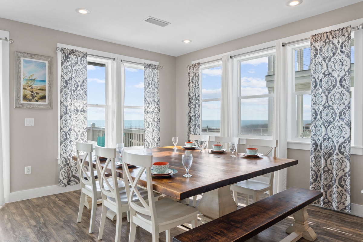 Gather around your elegant dining table for memorable meals while panoramic windows showcase stunning coastal views.