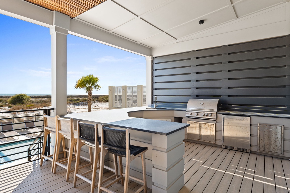 Grill memorable meals on your private terrace with stunning ocean views and modern outdoor kitchen.