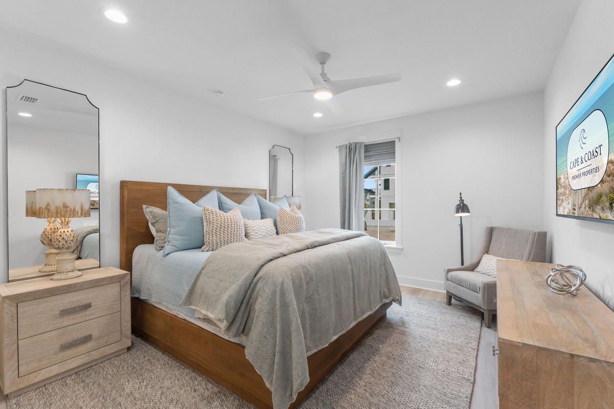 Your spacious bedroom features a plush king bed with coastal-inspired linens, creating a serene retreat where you'll drift off peacefully each night.