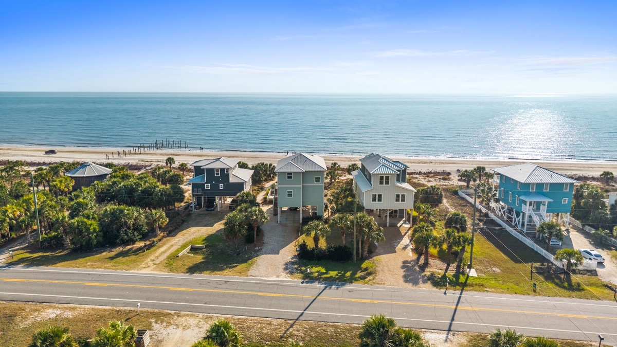 Beachfront vacation homes line the coast, offering direct beach access and stunning ocean views in this prime coastal location.