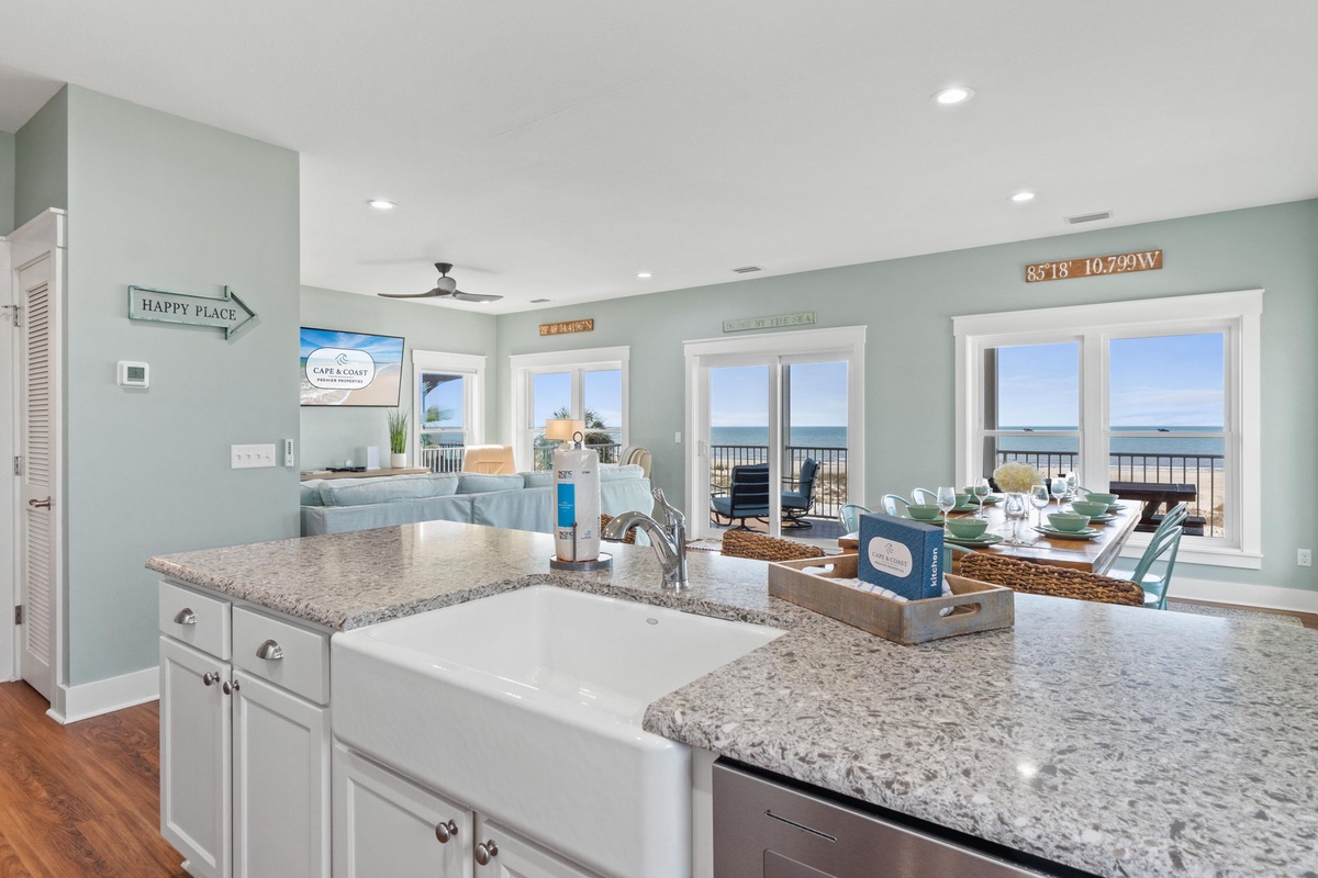 Gather around your coastal-inspired kitchen where granite countertops and beachy decor set the stage for meal prep while you soak in stunning ocean views through expansive windows.
