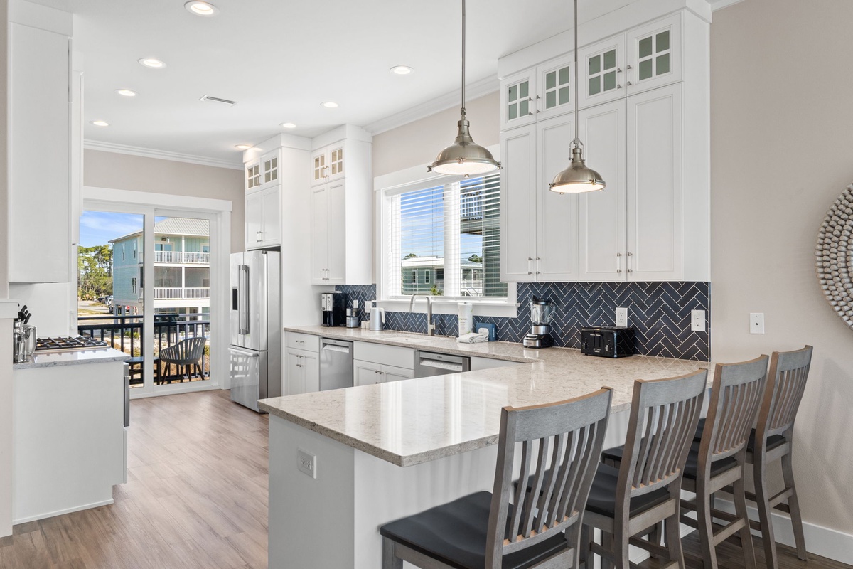 Your gourmet kitchen awaits with gleaming quartz countertops, modern appliances, and a spacious island perfect for morning coffee or evening cocktails.