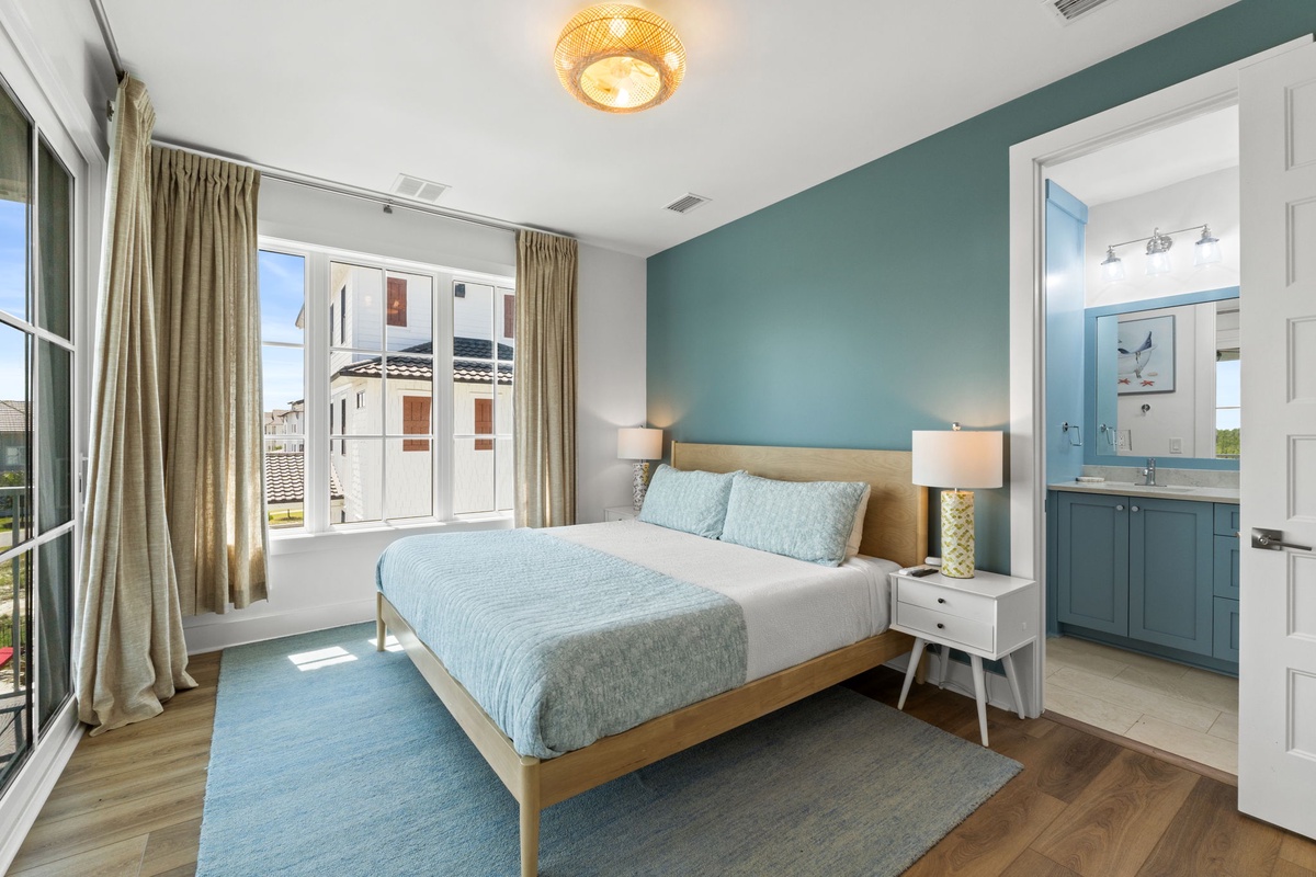Your tranquil retreat features a plush bed, soothing coastal tones, and an en-suite bathroom—perfect for unwinding after a day of exploring.