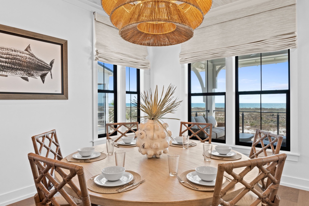 Gather around this elegant dining table where every meal becomes special, with stunning ocean views framing your dining experience.