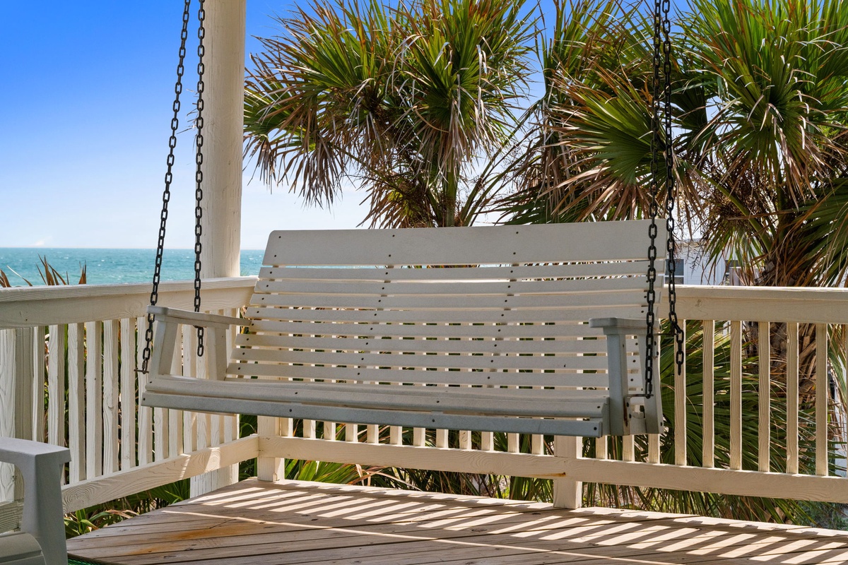 Relax on your private porch swing while taking in the soothing ocean breeze and tropical palm views—your perfect spot to unwind and watch the waves.