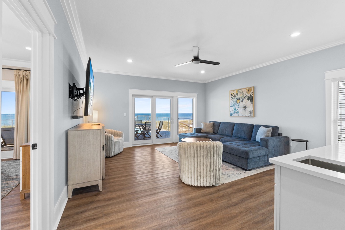 Sink into plush seating and gaze at breathtaking ocean views through wide glass doors. Your coastal retreat features modern elegance with coastal charm throughout.