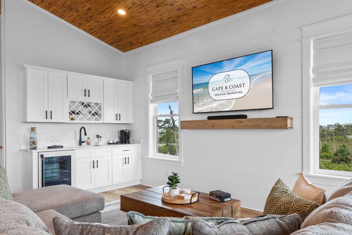 Unwind in your bright, modern living space with vaulted wood ceilings, cozy seating, and a wet bar stocked for your favorite drinks.