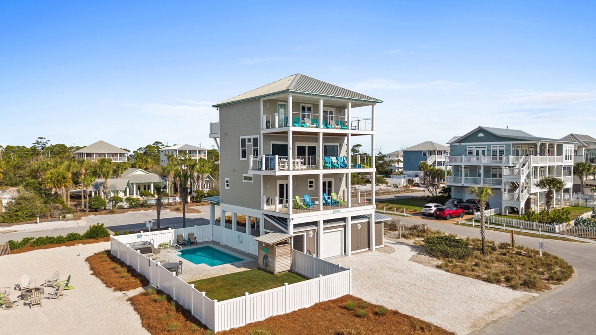 Modern beachside vacation home with private pool and multiple balconies in a coastal neighborhood setting.
