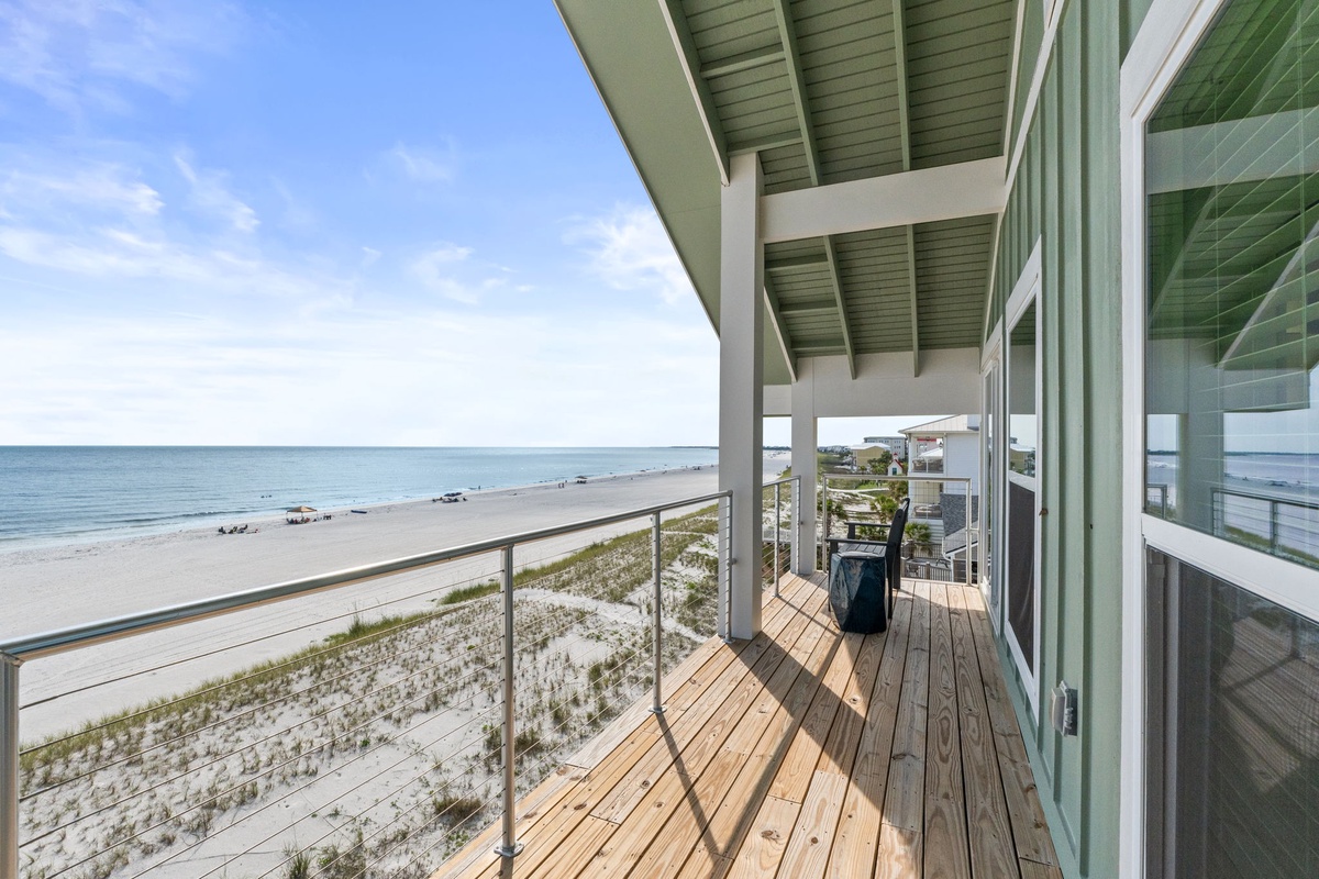 This private beachfront deck offers direct access to pristine sands and endless ocean views, perfect for morning coffee or evening relaxation steps from the shore.