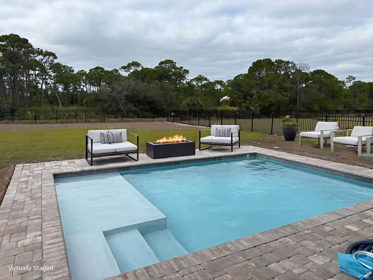 Unwind by your private pool with stylish seating and a crackling fire pit, surrounded by peaceful natural scenery.