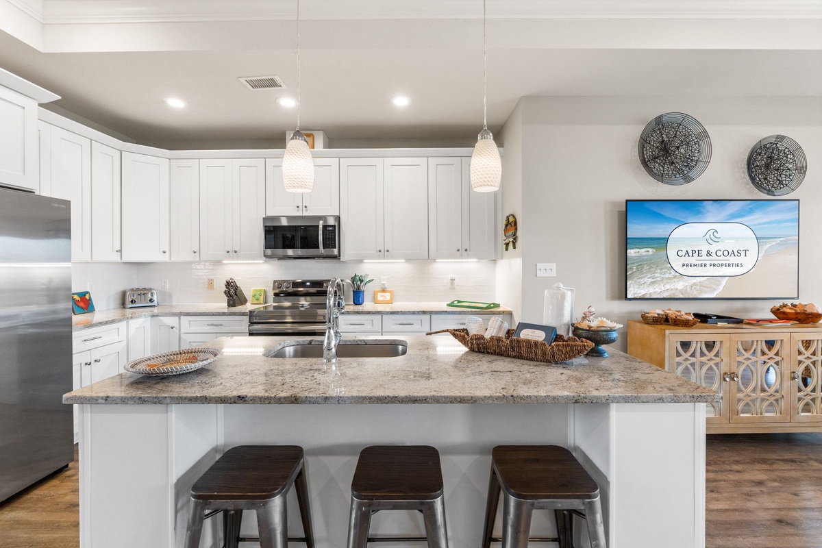 Your modern kitchen awaits with granite countertops, stainless appliances, and a spacious island perfect for preparing meals together.