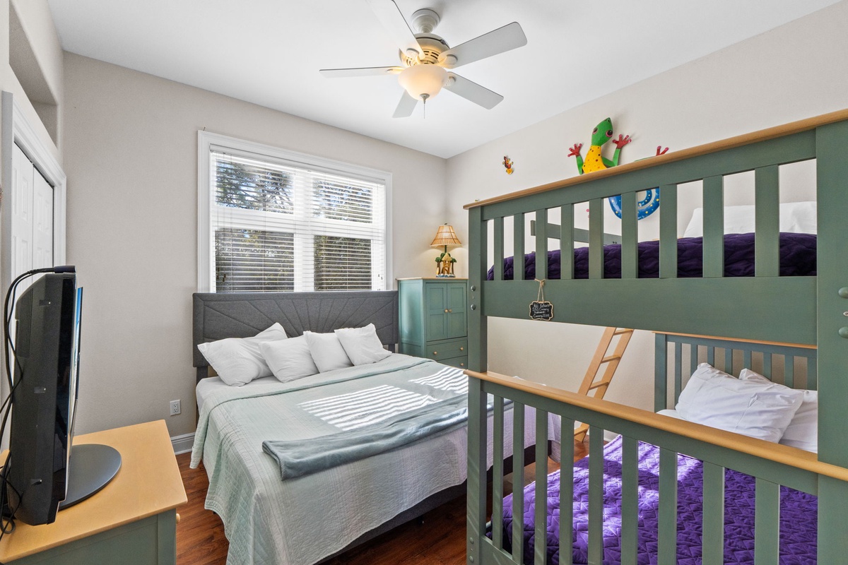 Your family bedroom features a cozy queen bed and fun bunk beds, perfect for kids' adventures and parents' comfort.