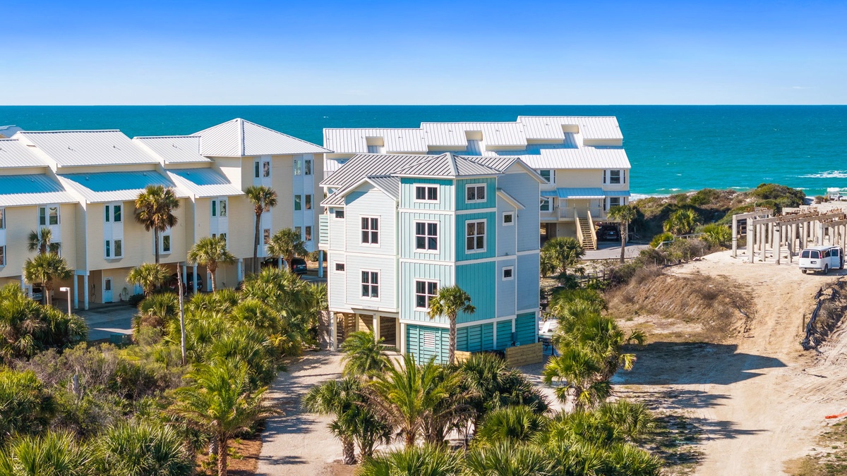 Coastal vacation rental with beachfront location, featuring modern architecture and direct ocean access with scenic turquoise waters.