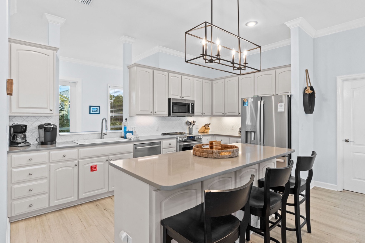 Your bright, modern kitchen offers everything you need with sleek white cabinets, stainless appliances, and a perfect island for morning coffee or casual meals.