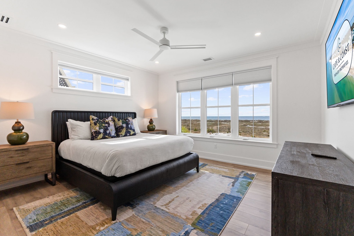 Relax in your bright bedroom where natural light flows through large windows, offering peaceful views of the surrounding landscape.